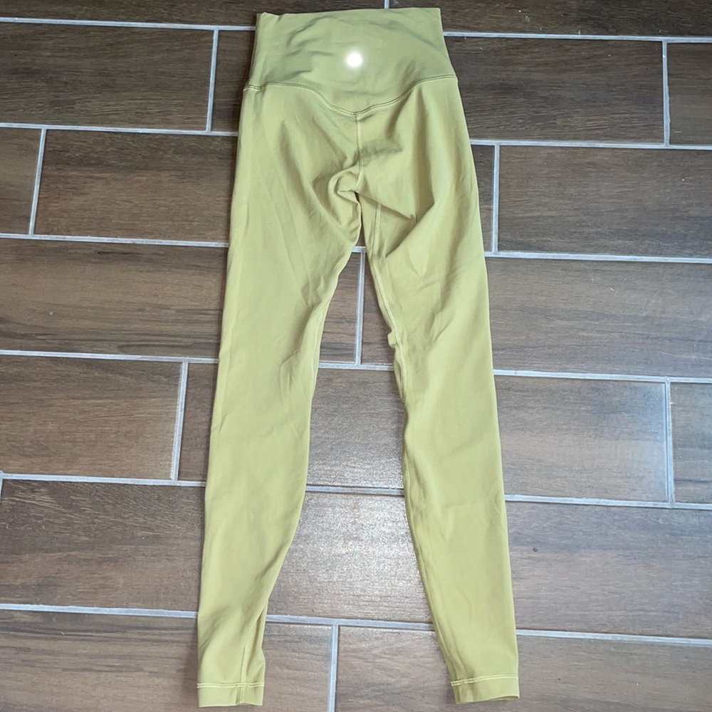 Never worn Lululemon leggings. The color is a yellow green